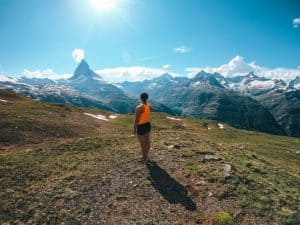 Woman standing in front of The Matterhorn and other mountains in Switzerland