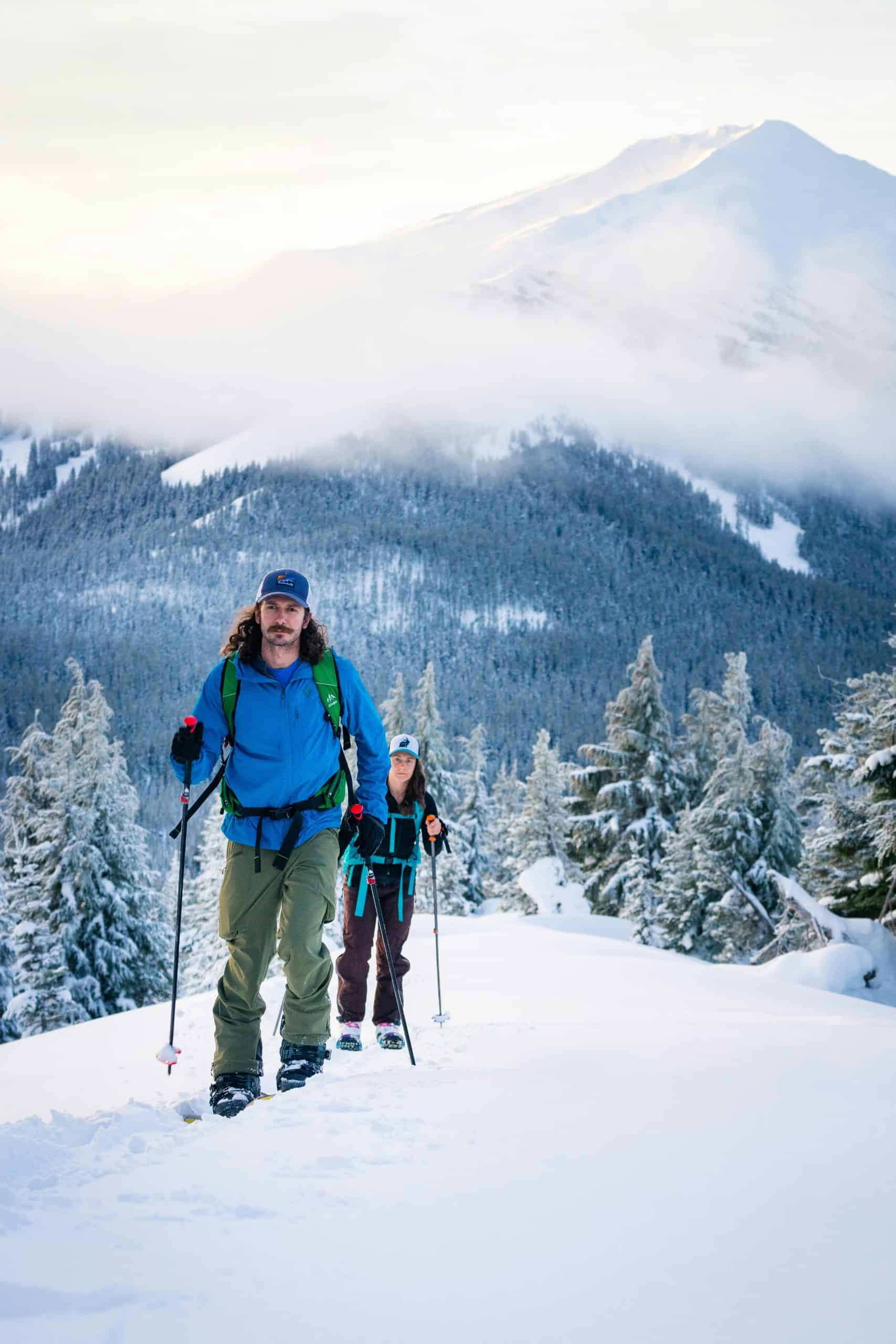 Two friends skiing on Mt. Bachelor during the winter. Skiing and snowboarding are two reasons why people love to visit Portland, Oregon.