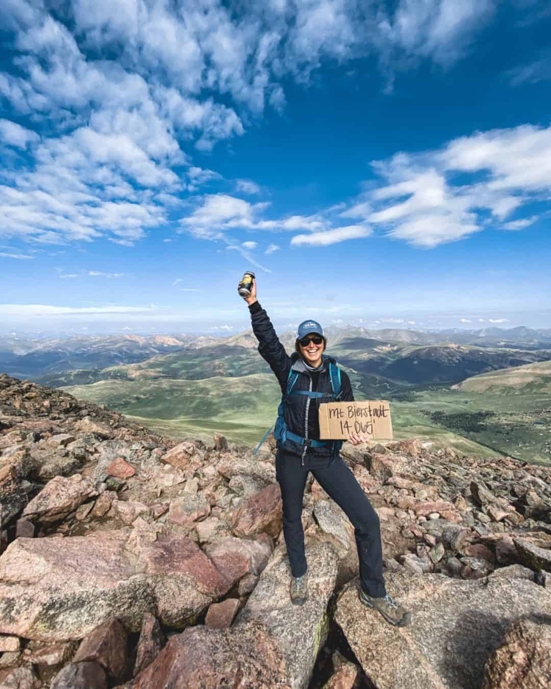 A woman that hiked a 14er in Colorado wearing some of the best women's hiking pants on a bluebird day.