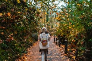 A woman walking through colorful leaves during fall in Bend, Oregon.