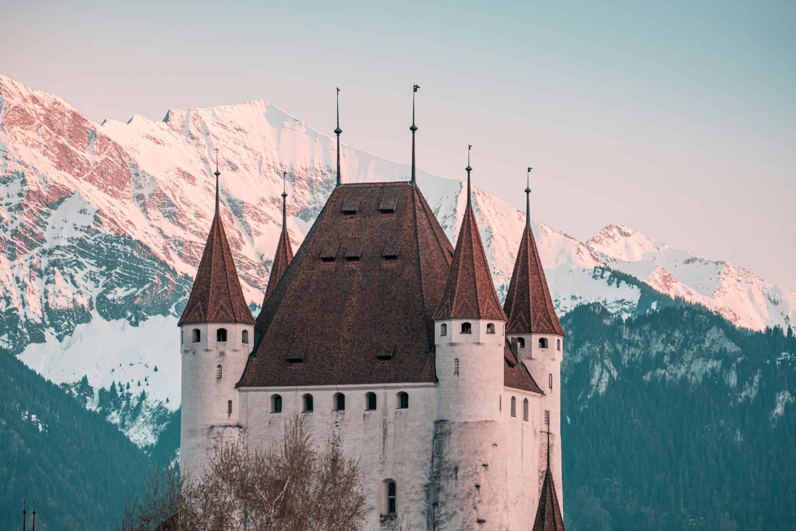 One of the castles of Switzerland, Schloss Thun. This castle overlooks the lake with a magnificent view of the Swiss Alps in the background. This castle dominates the skyline.