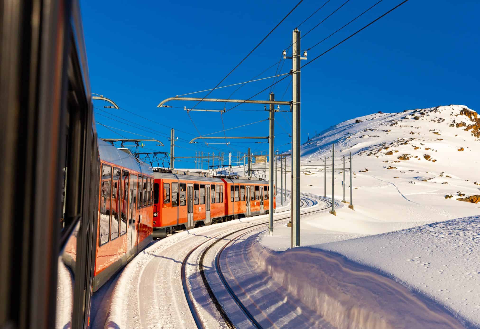 The trains in Switzerland are known for their beautiful scenery and bright red trains. 