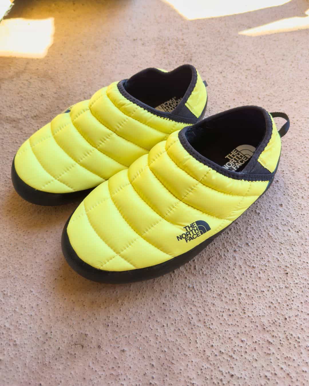 Yellow North Face Thermoball slippers are one of the best gifts for your outdoorsy gal.